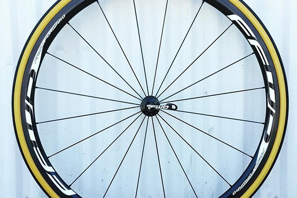 A side view of a FFWD wheel with a Quick release skewer